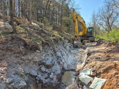 Trench with machinery in background 3/27/2026