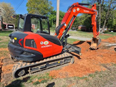 An image of a backhoe on freshly compacted clay 